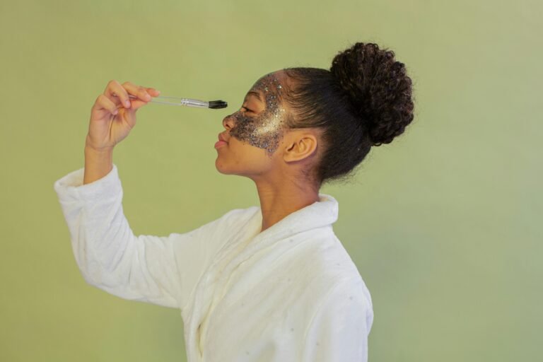 African American woman applying a facial mask in a studio setting, showcasing a skincare routine.